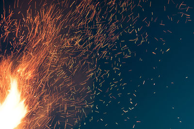 Close-up of sparks at night