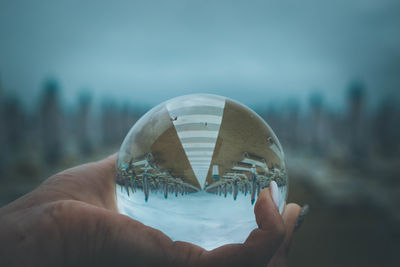 Close-up of hand holding crystal ball