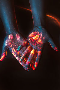 Close-up of illuminated lighting equipment against black background