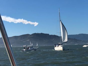 Sailboat sailing on sea against sky