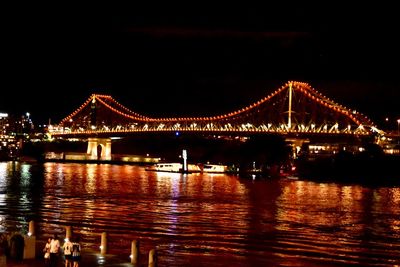 Illuminated suspension bridge at night