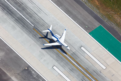 High angle view of airplane on airport runway