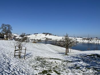 Snow covered field against sky