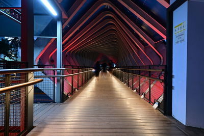 Rear view of people on footbridge