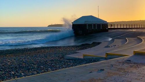 Scenic view of sea against clear sky during sunset