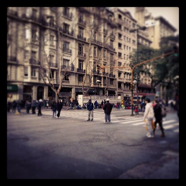 building exterior, architecture, large group of people, built structure, transfer print, city, street, city life, auto post production filter, person, men, walking, city street, lifestyles, day, incidental people, outdoors, building, road