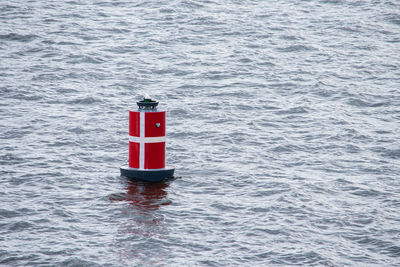 Side buoys marking the fairway against the background of the sea