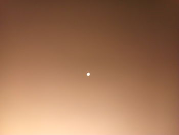 Low angle view of moon against sky at night