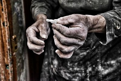 Midsection of messy senior woman holding crystal