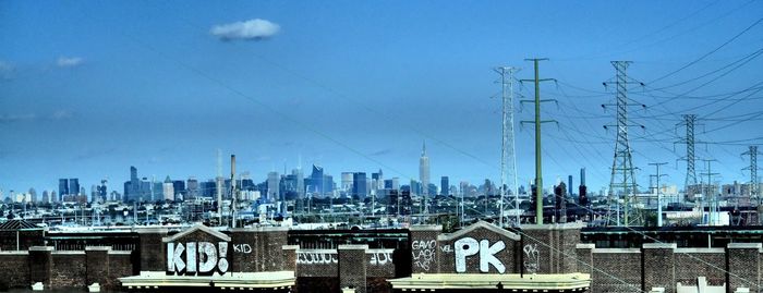 View of cityscape against blue sky