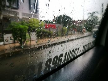 Close-up of wet car window during rainy season