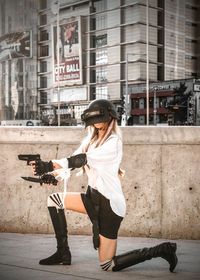 Woman with umbrella on street in city