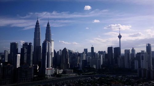 Skyscrapers against cloudy sky