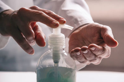 Close-up of hand holding glass bottle