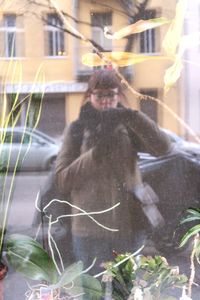 Man photographing through window