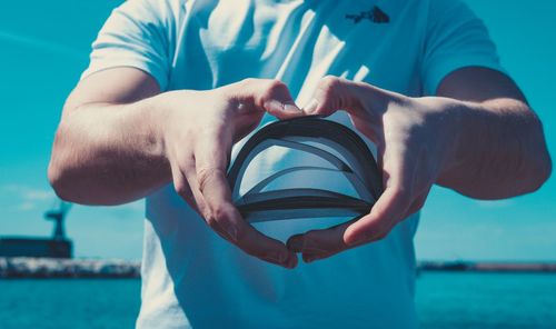 Midsection of man holding swimming pool