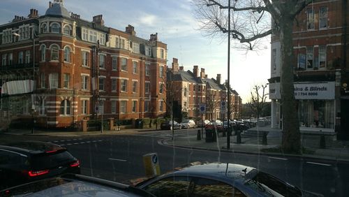 City street by buildings against sky