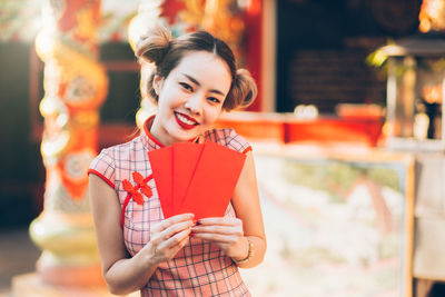 Portrait of a smiling young woman standing outdoors