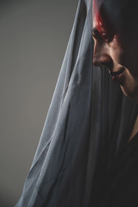 Close-up of young man against gray background