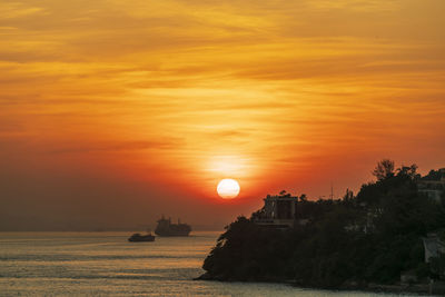 Scenic view of sea against romantic sky at sunset