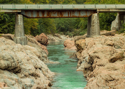 Bridge over river amidst rocks