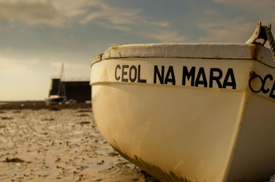 Close-up of text on boat at beach