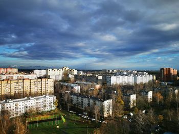 High angle view of buildings against cloudy sky