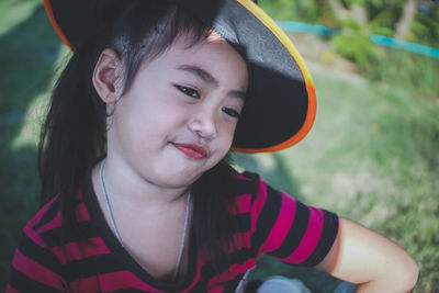 Girl wearing witch hat looking away