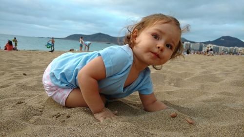 Boy on beach against sky