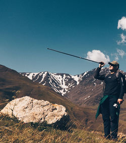 Man standing on mountain road against sky