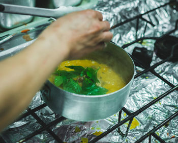 Cropped image of person preparing food in kitchen