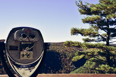 Close-up of coin-operated binoculars against clear sky