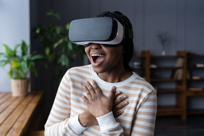 Surprised woman use vr glasses headset simulator enjoy experience from virtual reality goggles games