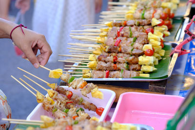 Close-up of hand holding food on table