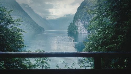 Scenic view of river by mountains against sky