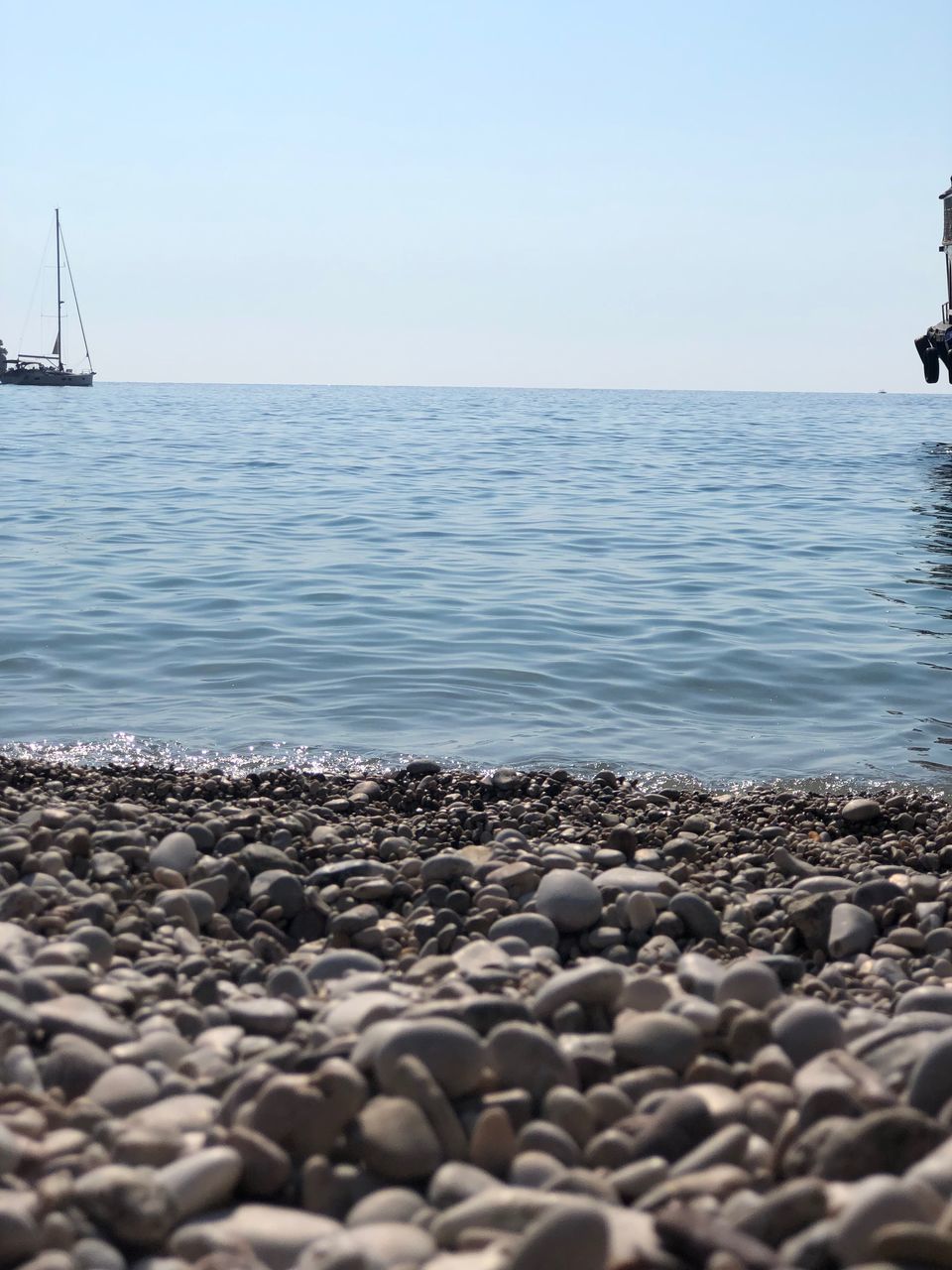 STONES ON BEACH AGAINST SKY