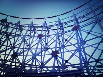 Low angle view of ferris wheel against blue sky