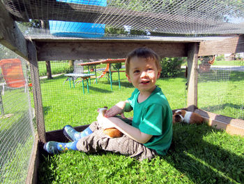 Portrait of boy sitting on grass