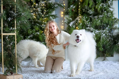 Portrait of teenager girl with dogs at home