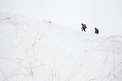 Couple hiking on snowcapped mountain in vacation