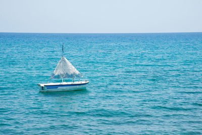 A small boat with no people and blue waters on a sunny day. close to lindos, rhodes, greece