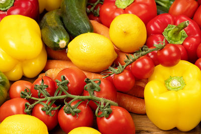 Fresh seasonal vegetables tomatoes carrots lemons and peppers