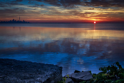 Scenic view of lake ontario against cloudy sky during sunset