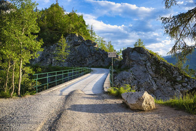 Road amidst trees against sky