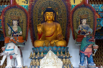 Buddha statue in temple outside building