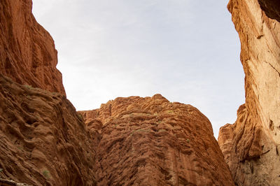 Low angle view of rock formations against sky