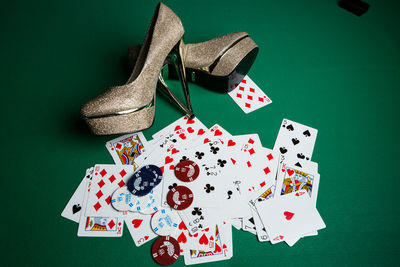 High angle view of cards and high heels on table