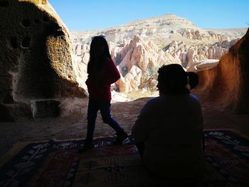 Rear view of people standing on mountain