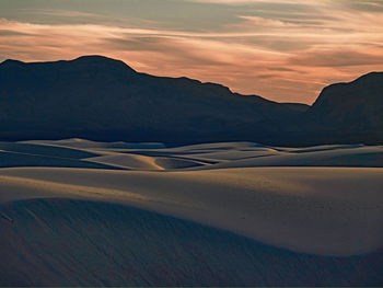 Scenic view of desert against sky during sunset