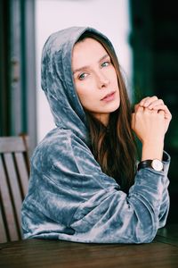 Portrait of beautiful young woman sitting outdoors